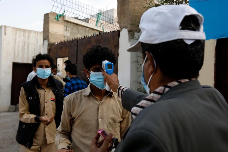 A student gets his temperature checked at a school in Sanaa, Yemen. EPA
