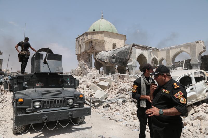 Iraqi special forces mill around the entrance of the destroyed Al Nuri Mosque.  Florian Neuhof  / The National