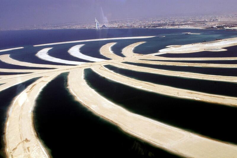 An aerial view shows the 17 fronds of the palm tree-shaped resort island on land reclaimed from the sea that will be visible from the moon, south of Dubai 17 November 2003. The Gulf emirate unveiled plans to build the resort which will include 2,000 villas, up to 40 luxury hotels, shopping complexes, cinemas and the Middle East's first marine park. With its oil resources running out, Dubai has launched a multi-billion dollar tourism drive in an effort to establish itself as the gulf's leisure hub.   AFP PHOTO/Rabih MOGHRABI (Photo by RABIH MOGHRABI / AFP)