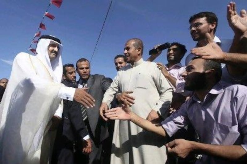 Qatar’s emir, Sheikh Hamad bin Khalifa Al Thani, is greeted by Palestinians at cornerstone laying ceremony for a new centre providing artificial limbs in the northern Gaza Strip.