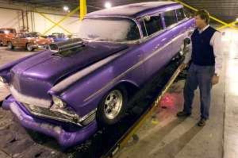 This Dec. 29, 2009 photo shows auctioneer Rob Olson looking over a seized 1956 Chevy Wagon as it is being delivered at a warehouse in Salt Lake City. Erkelens & Olson Auctioneers are selling nearly 200 muscle, luxury, classic and replica cars that belonged to Jeffrey Mowen, who was arrested for running a Ponzi scheme that took in more than $18 million. The auction is set for Jan. 7 and Jan. 21. (AP Photo/The Salt Lake Tribune, Jim Urquhart) **DESERET NEWS OUT, NO MAGS** *** Local Caption ***  mo09ja news brief.jpg