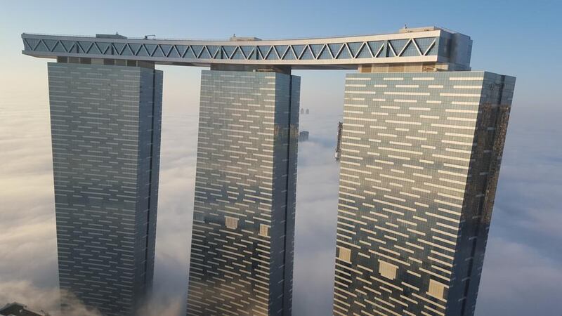 Reem Island's Gate Towers stand tall above the cloud line in Abu Dhabi. Thamer Al Subaihi / The National
