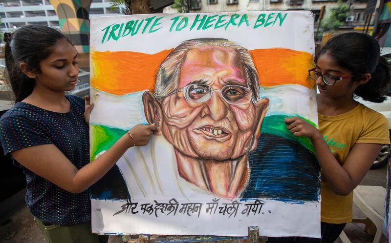 Students from the Gurukul School of Art in Mumbai display a painting of Mr Modi's mother. EPA