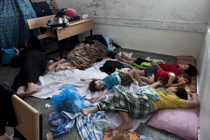Palestinians sleep in a classroom as they take shelter at the UNRWA New Gaza Boys Prep school in the Refugee Beach Camp on July 14. Heidi Levine for The National