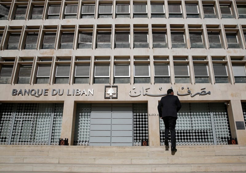 A man heads to the Lebanese central bank, in Beirut, Lebanon, Tuesday, Jan. 22, 2019. Lebanon's finance minister says a report by Moody's Investors Service that downgraded the country's long-term investment ratings reflect the need for quickly forming a new government and implement financial reform. Ali Hassan Khalil's tweet on Tuesday came hours after Moody's downgraded the Lebanon's issuer ratings to Caa1 from B3. (AP Photo/Hussein Malla)