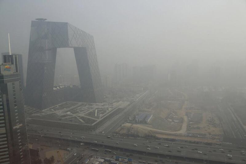 The China Central Television building, left, during a heavy haze in Beijing’s central business district in January. Jason Lee / Reuters