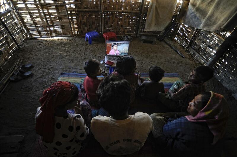 Members of Senwara Begum's family watch her video interview at the Ohn Taw refugee camp on the outskirts of Sittwe, Myanmar. AP Photo/Kaung Htet