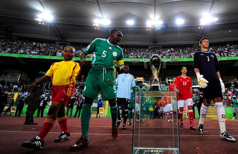 Nigeria's Fortune Chukwudi looks at the Fifa Under 17 World Cup trophy before the start of the finals match against Switzerland at the Abuja National Stadium on November 15, 2009, in Abuja, Nigeria. A former Nigerian international later claimed in a newspaper column that Chukwudi was 25 years old at the time.  Jamie McDonald /  Getty Images