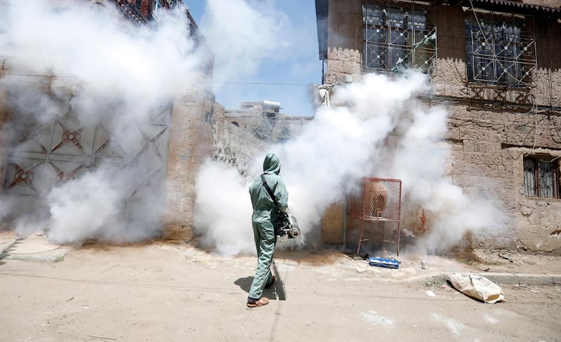 A Yemeni worker fumigates a neighbourhood as a precaution against the spread of the coronavirus Covid-19. EPA