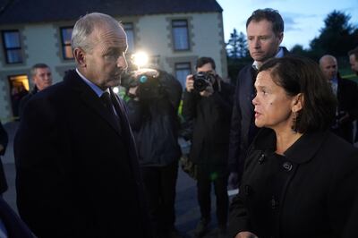 Taoiseach Micheal Martin speaks to Sinn Fein leader, Mary Lou McDonald, at the scene of an explosion at Applegreen service station. PA