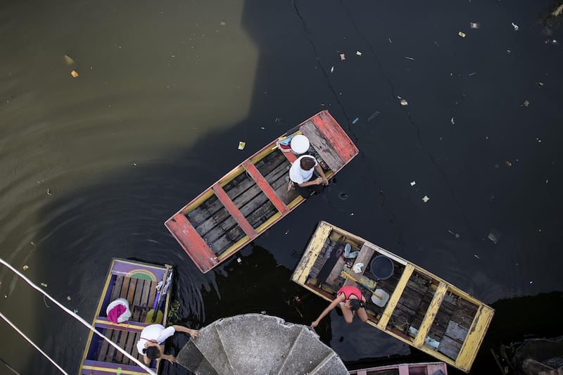 Residents ride on boats to cross stagnant floodwaters in Manila, Philippines, on July 6, 2018. Noel Celis / AFP