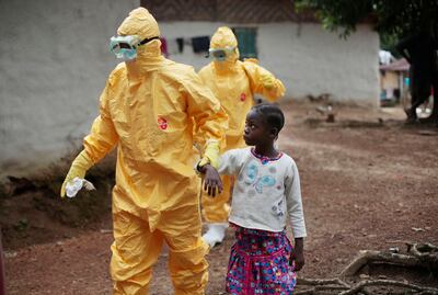 Health workers escort a girl suspected to be infected with Ebola to an ambulance during a 2014 outbreak in Liberia. AP 