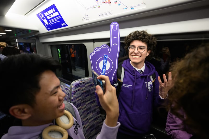 Underground enthusiasts travel on the first eastbound train as the Elizabeth line opens at Paddington station in central London on May 24. Getty Images