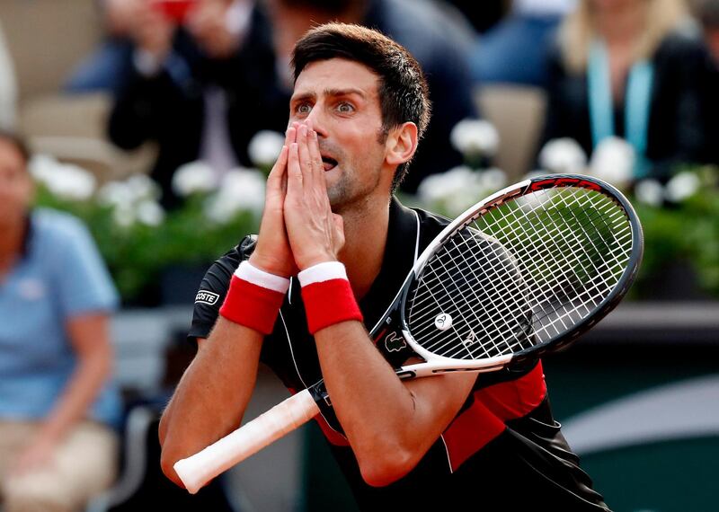 epaselect epa06787397 Novak Djokovic of Serbia reacts as he plays Marco Cecchinato of Italy during their men’s quarter final match during the French Open tennis tournament at Roland Garros in Paris, France, 05 June 2018.  EPA/GUILLAUME HORCAJUELO