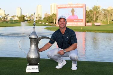 DUBAI, UNITED ARAB EMIRATES - JANUARY 31: Paul Casey of England celebrates with the winners trophy after the final round of the Omega Dubai Desert Classic at Emirates Golf Club on January 31, 2021 in Dubai, United Arab Emirates. (Photo by Ross Kinnaird/Getty Images)