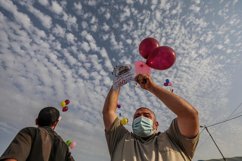 Palestinians release balloons with posters of Palestinian prisoner Maher al-Akhras who is held in an Israeli jail during a protest supporting him near the border with Israel in the east of Gaza City. EPA