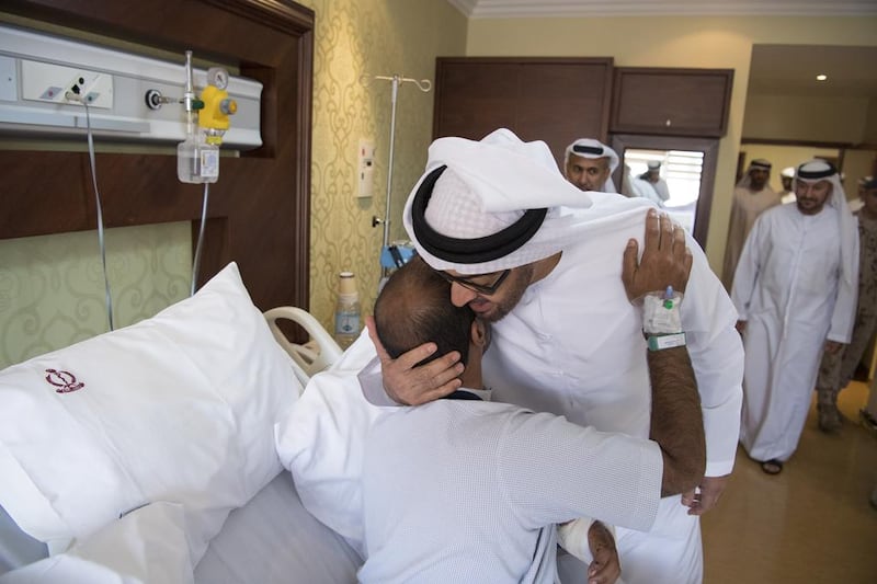 Sheikh Mohammed bin Zayed, Crown Prince of Abu Dhabi and Deputy Supreme Commander of the Armed Forces, visits Fadhel Ahmed Al Meheiri (centre L) who was injured while serving in Yemen, at Zayed Military Hospital. Hamad Al Kaabi / Crown Prince Court — Abu Dhabi