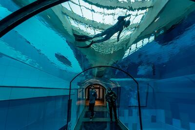 A diver is seen in the deepest pool in the world with 45.5-metre (150-foot) located in Mszczonow about 50 km from Warsaw, November 21, 2020.  The complex, named Deepspot, even includes a small wreck for scuba and free divers to explore. It has 8,000 cubic metres of water -- more than 20 times the amount in an ordinary 25-metre pool.
 / AFP / Wojtek RADWANSKI / TO GO WITH AFP STORY 
