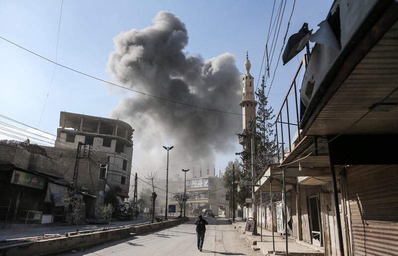 Smoke rises from another regime air strike in the rebel-held enclave of Hamouria. Abdulmonam Eaasa / AFP Photo