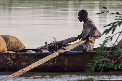 A farmer ferries his crops on the Nile river near the Karari area north of Omdurman, Sudan, on July 7. AFP