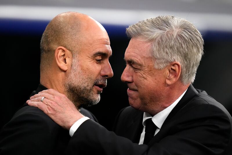 Real Madrid coach Carlo Ancelotti greets Manchester City  manager Pep Guardiola before the kick-off. AP 