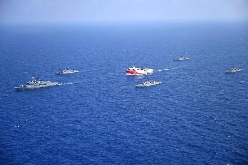 This handout photograph released by the Turkish Defence Ministry on August 12, 2020, shows Turkish seismic research vessel 'Oruc Reis' (C) as it is escorted by Turkish Naval ships in the Mediterranean Sea, off Antalya on August 10, 2020. - Greece on August 11, demanded that Turkey withdraw a research ship at the heart of their growing dispute over maritime rights and warned it would defend its sovereignty, calling for an emergency meeting of EU foreign ministers to resolve the crisis. Tensions were stoked August 10, when Ankara dispatched the research ship Oruc Reis accompanied by Turkish naval vessels off the Greek island of Kastellorizo in the eastern Mediterranean. (Photo by - / TURKISH DEFENCE MINISTRY / AFP) / RESTRICTED TO EDITORIAL USE - MANDATORY CREDIT "AFP PHOTO /TURKISH DEFENCE MINISTRY " - NO MARKETING - NO ADVERTISING CAMPAIGNS - DISTRIBUTED AS A SERVICE TO CLIENTS