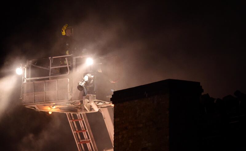 A firefighter tackles a fire at Camden Market in north London, Britain, July 10, 2017. REUTERS/Hannah McKay