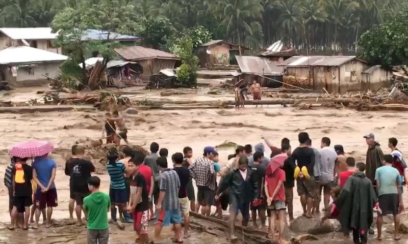 People help rescue flood victims in Lanao Del Norte, Philippines, December 22, 2017 in this image taken from video footage obtained from social media. Climah Cabugatan Disumala / Reuters
