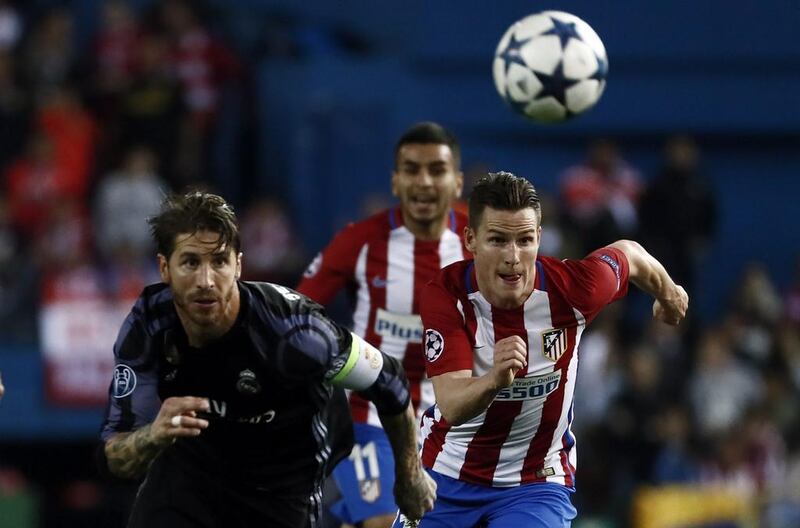 Atletico de Madrid’s Kevin Gameiro, right, vies for the ball with Real Madrid’s Sergio Ramos. Mariscal / EPA