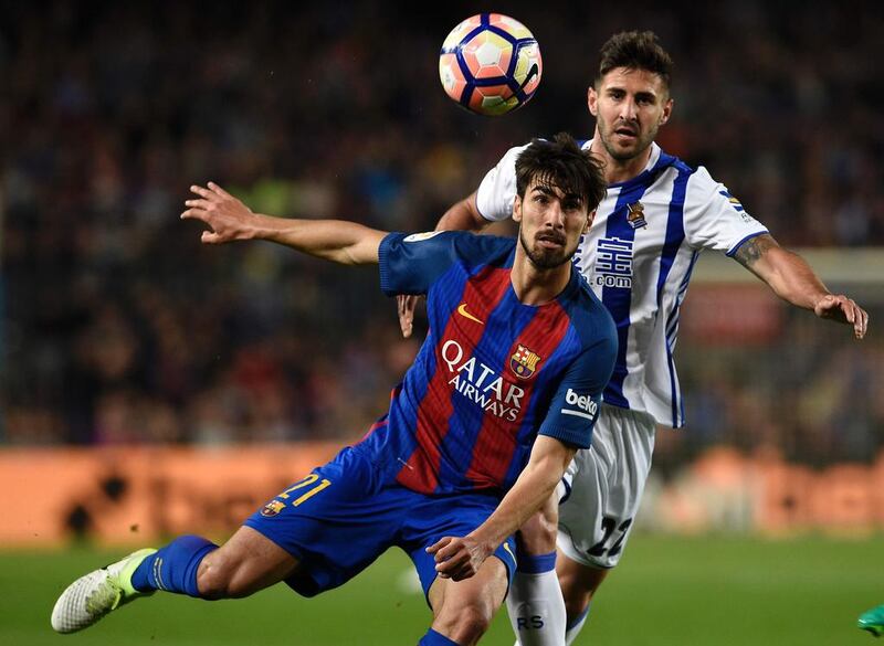 Barcelona’s Portuguese midfielder Andre Gomes, left, vies with Real Sociedad’s Brazilian forward Raul Navas. Lluis Gene/ AFP