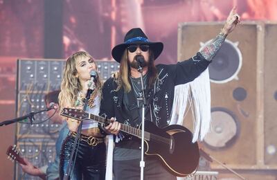 GLASTONBURY, ENGLAND - JUNE 30: Miley Cyrus and Billy Ray Cyrus  perform on the Pyramid Stage during day five of Glastonbury Festival at Worthy Farm, Pilton on June 30, 2019 in Glastonbury, England. (Photo by Samir Hussein/WireImage/Getty Images)
