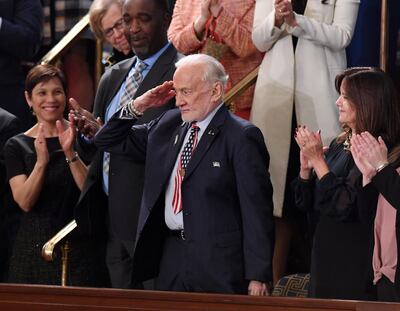 Former NASA astronaut Buzz Aldrin salutes as he is recognized by US President Donald Trump during the State of the Union address at the US Capitol in Washington, DC, on February 5, 2019.
 / AFP / SAUL LOEB
