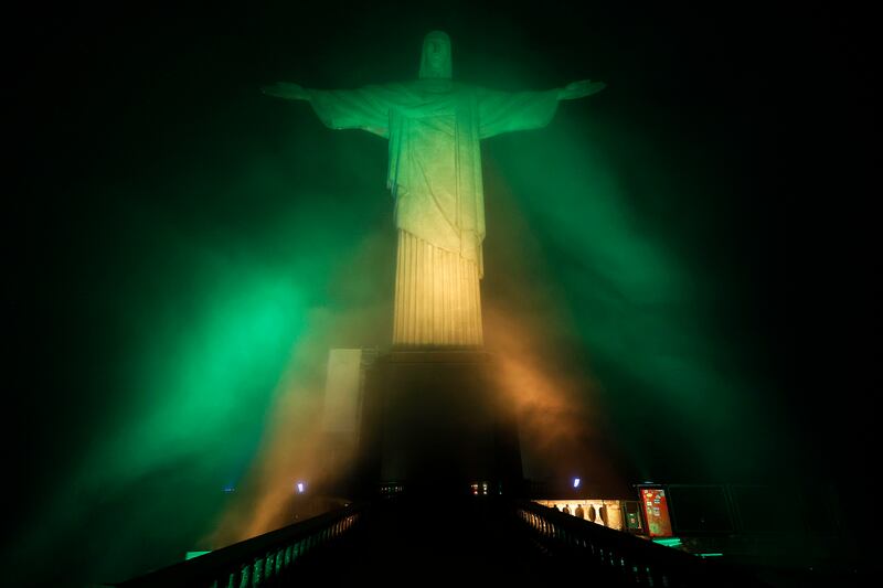 Christ the Redeemer statue is lit with the colours of the Brazilian flag to pay homage to Pele. Getty