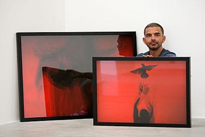 Syrian artist Jaber Al Azmeh with his work at the Green Art Gallery in Alserkal Avenue in Dubai. Pawan Singh / The National