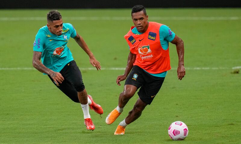 Brazil's Alex Sandro, right, and Raphinha practice during a training session in Manaus. AP Photo