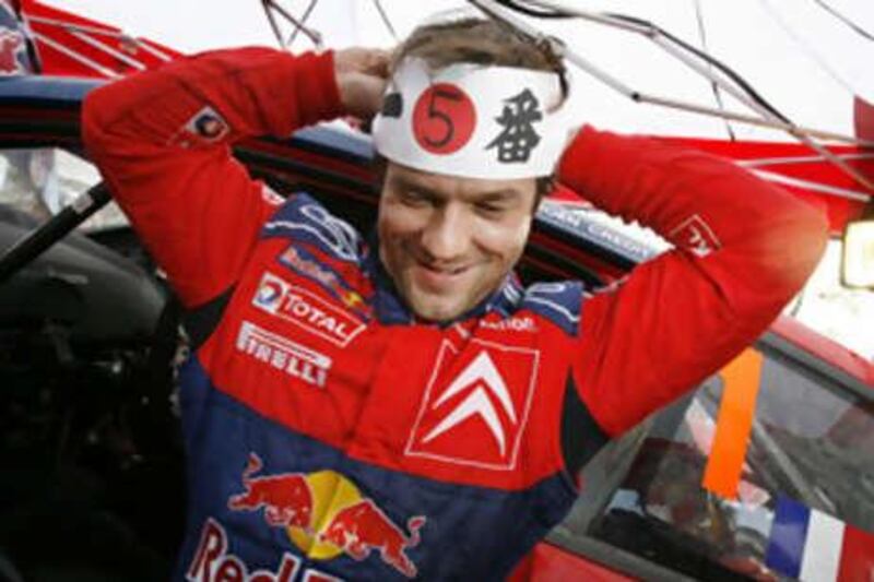 Sebastien Loeb of the Citroen team celebrates after claiming his fifth WRC title with a third place finish at the Rally of Japan.