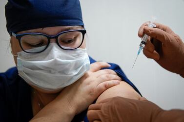 A medic receives Russia's Sputnik V vaccine shot against the coronavirus. Reuters
