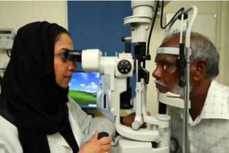 Dubai, 27th July 2008.  Dr. Manal Taryam (Head of Ophthalmology of the UAE) with the patient Yousef Sulaiman, during the examination, at the Outpatient Clinic in Rashid Hospital  (Jeffrey E. Biteng / The National) *** Local Caption ***  JB0592-Taryam.jpg
