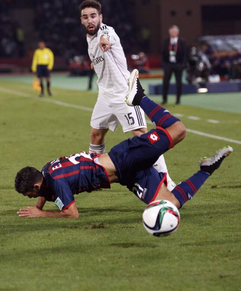 Emmanuel Mas (L) of San Lorenzo fights for the ball with Real Madrid's Carvajal during their Club World Cup final soccer match at the Marrakech stadium December 20, 2014. REUTERS/Youssef Boudlal (MOROCCO - Tags: SPORT SOCCER)