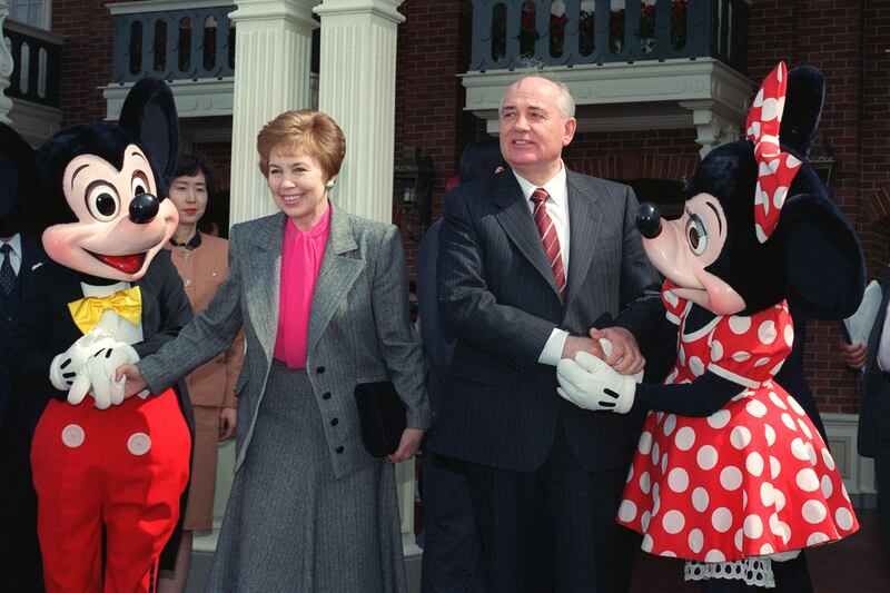 Gorbachev and his wife shake hands with Mickey and Minnie Mouse at the entrance of Disneyland, Tokyo, in April 1992. AFP