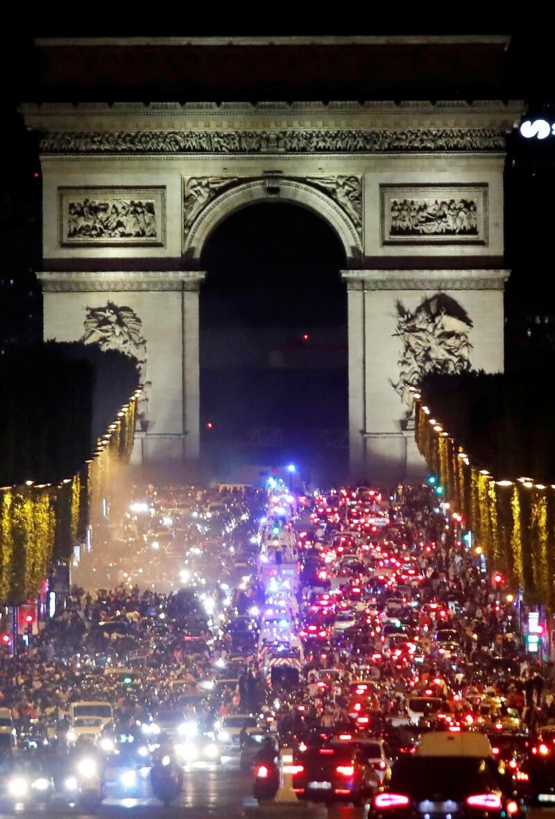 PSG fans celebrate in front of the Arc de Triomphe. Reuters