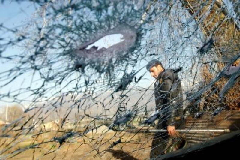 An Indian policeman is seen through a car's damaged windshield after a shootout in Srinagar March 10, 2011. Two militants belonging to Jaish-e-Mohammad, a Pakistan based militant group, were killed in a shootout in Srinagar on Thursday, police said. REUTERS/Danish Ismail (INDIAN-ADMINISTERED KASHMIR - Tags: CIVIL UNREST CRIME LAW IMAGES OF THE DAY) *** Local Caption ***  SRI05_KASHMIR-_0310_11.JPG