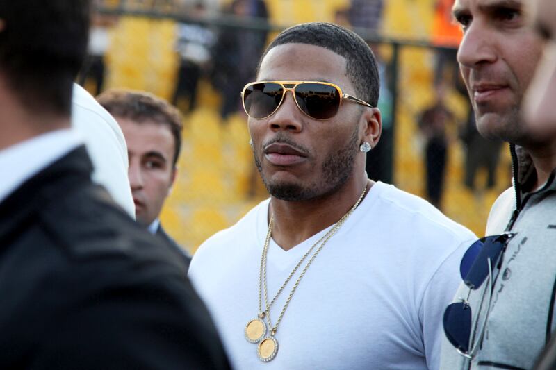 FILE- In March 13, 2015, file photo, rapper Nelly approaches the stage for a concert in Irbil, northern Iraq. Police have arrested Nelly after a woman said he raped her in a town outside Seattle, an accusation the Grammy winner's attorney staunchly denies. Auburn police spokesman Commander Steve Stocker said officers arrested Nelly early Saturday, Oct. 7, 2017, morning in his tour bus at a Walmart.  (AP Photo/Seivan M. Salim, File)