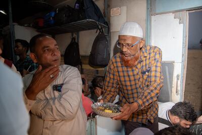 Ahmed Najeeb offers iftar food to co-passengers in the train. Mahendra Parikh for The National