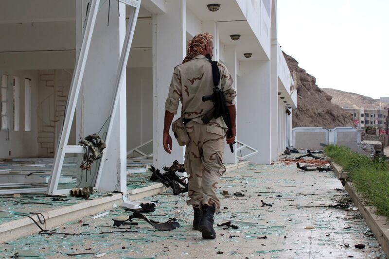 A fighter from the separatist Southern Transitional Council gather on February 25, 2018, at the site of two suicide car bombings that targeted the headquarters of an anti-terror unit the day before, in the southern Yemeni port of Aden.
Five people, including security officers and a child, died in the blasts at the headquarters of an anti-terror unit in the Tawahi district, Aden security chief General Shallal al-Shae said.
 / AFP PHOTO / SALEH AL-OBEIDI