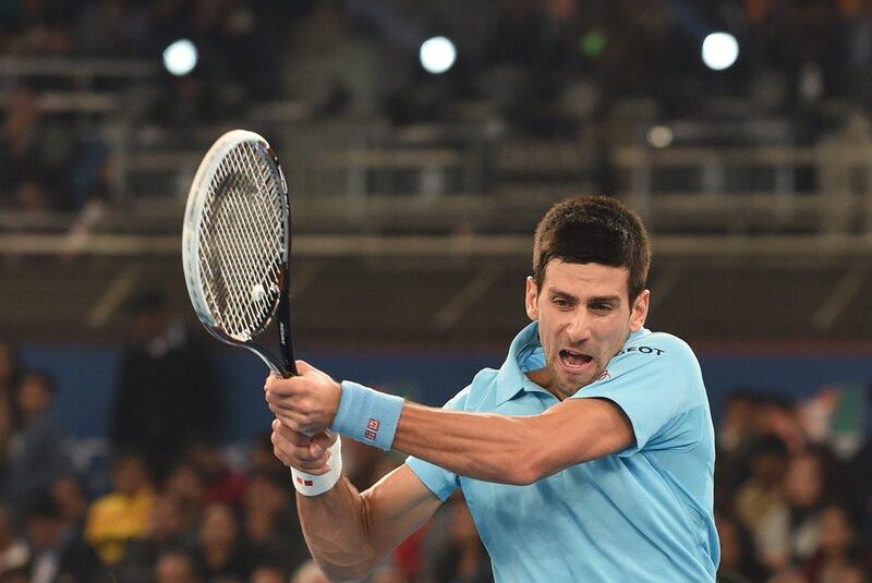 Novak Djokovic plays a shot during his match against Roger Federer at the International Premier Tennis League match in New Delhi on Monday. Sajjad Hussain / AFP / December 8, 2014