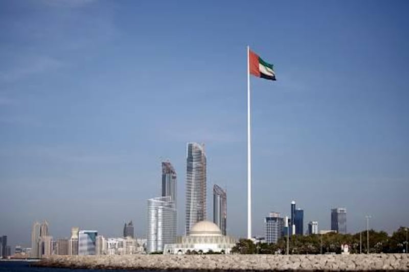 October 31, 2011 (Abu Dhabi) The UAE National flag blows in the wind with the Abu Dhabi skyline behind it October 31, 2011.  (Sammy Dallal / The National)