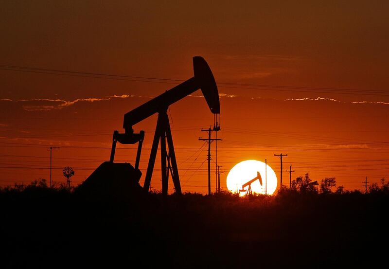 FILE - In this June 11, 2019, file photo a pump jack operates in an oil field in the Permian Basin in Texas. Drilling of the longest horizontal oil and gas well in the history of the Permian Basin has been completed as booming oil production in the region continues to center around shale in southeast New Mexico and West Texas. (Jacob Ford/Odessa American via AP, File)