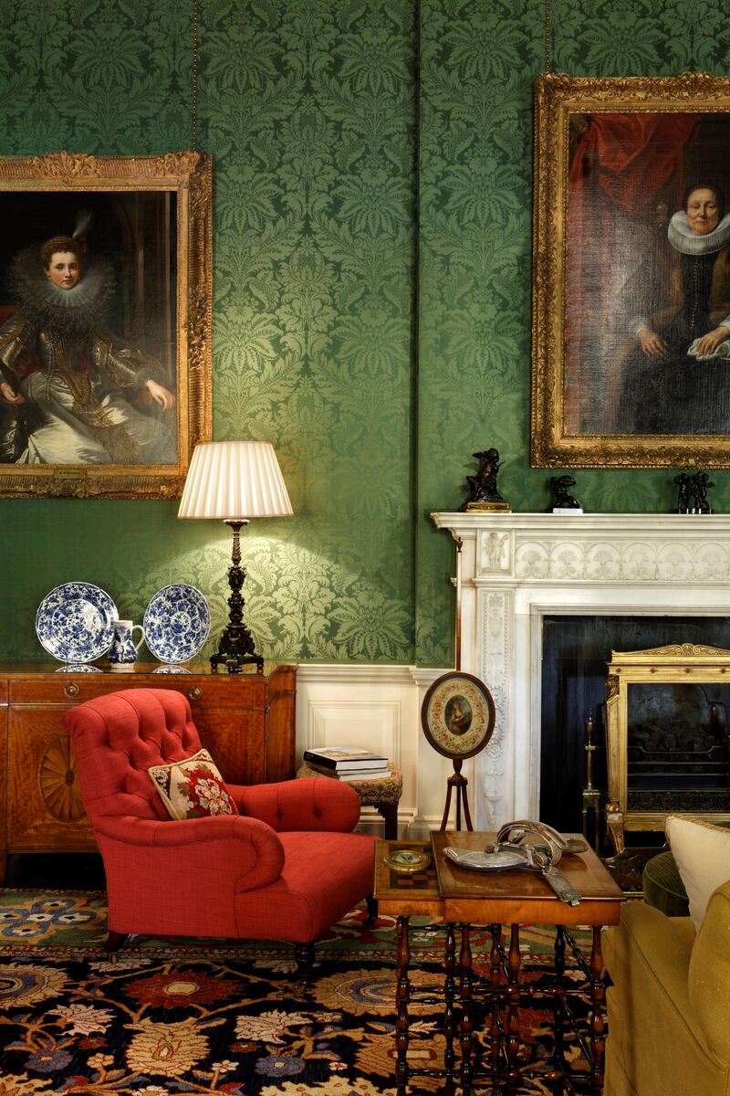 Despite its apparent formality, the Dutch Room at Buscott Park has a gentle,  inviting charm. The new hand-dyed, green silk damask walls are based on an old design, but I colored the fabric so it should be  unique to the house; the walls below the dado are painted trompe lâ€™oeil designed to trick the eye into believing they are three-dimensional moulded panels. The joy of this room is the fine English furniture and the paintings, which include works by Rembrandt and Rubens. My job was to reposition and subtly restore and reupholster. The uncluttered and elegant design for the new Zeigler rug was based on late nineteenth-century Zeigler designs, that were specifically made in Iran for houses such as this. (Photo by James McDonald)