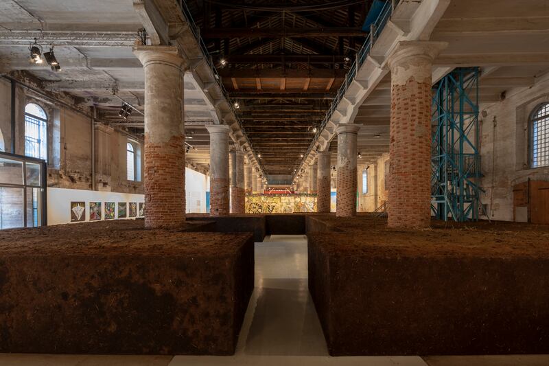 Delcy Morelos' 'Earthly Paradise, 2022', fills the cavernous Arsenale with packed, redolent earth. Photo: Roberto Marossi